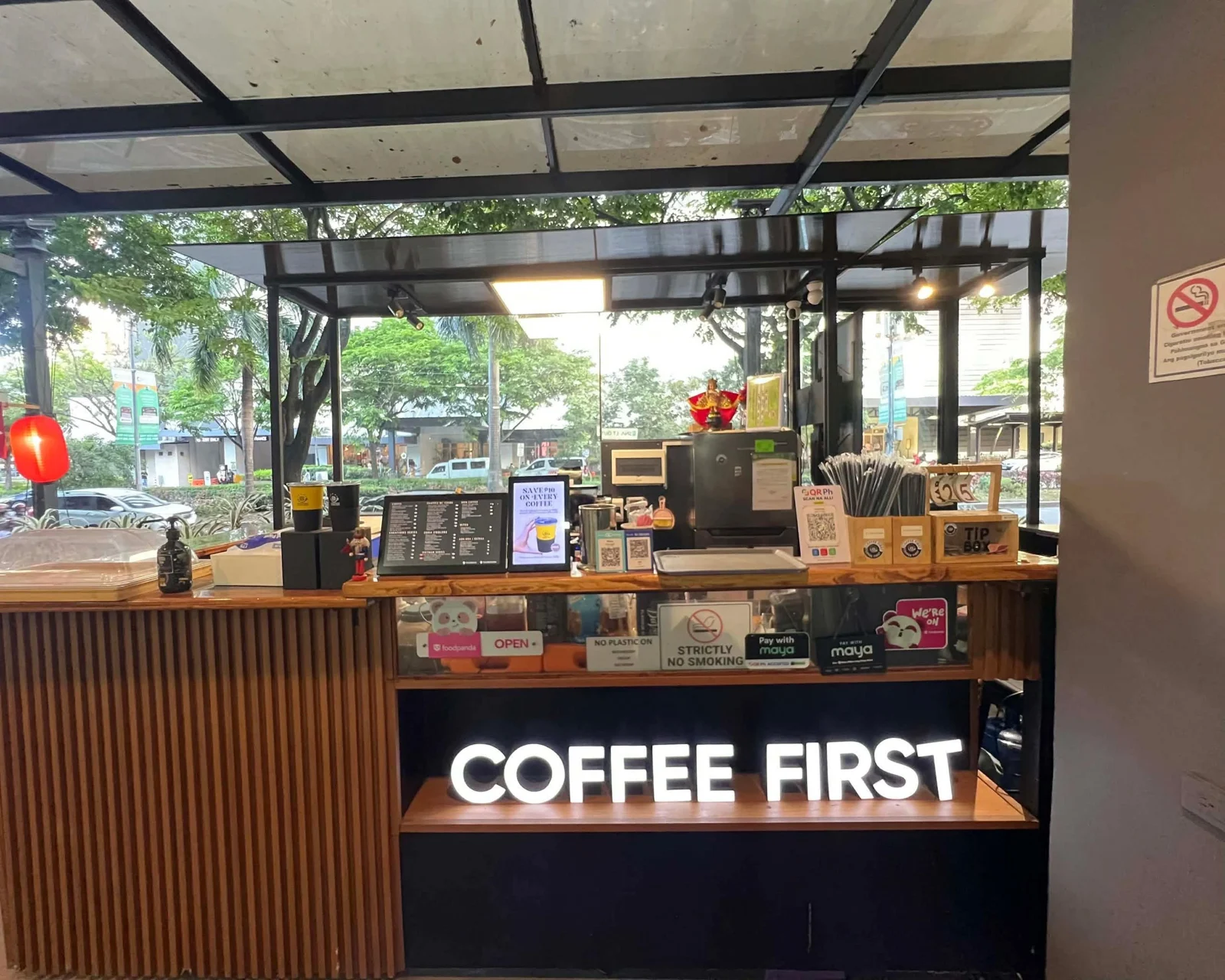 Coffee First Skyrise 1 counter with illuminated Coffee First sign